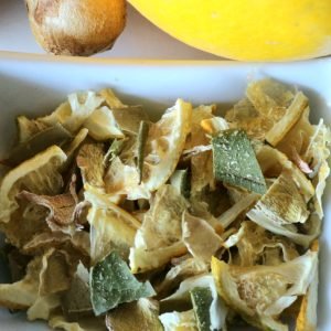 Ramekin of Lemon & Ginger Twist with a lemon and a hunk of ginger