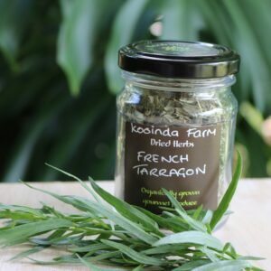 Jar of French tarragon dried herbs with a bunch of fresh tarragon